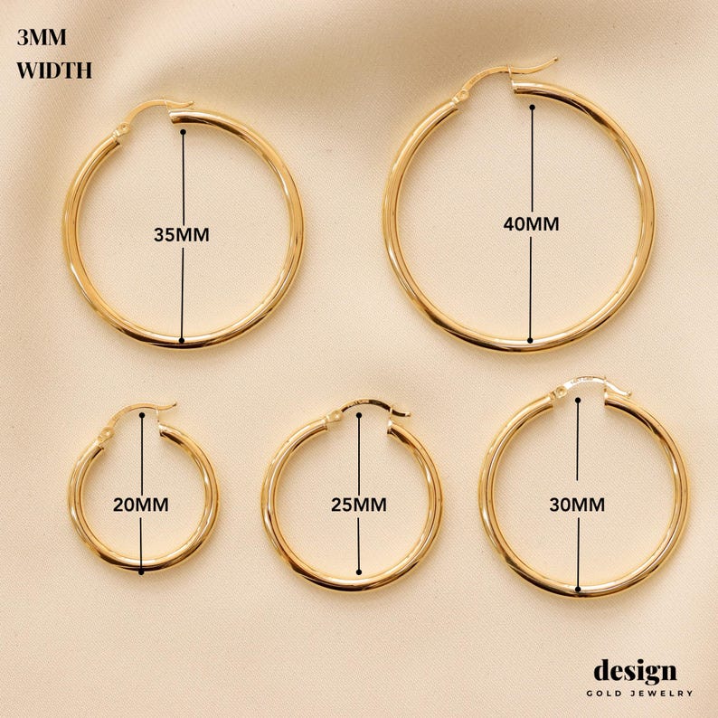 May include: Four pairs of gold hoop earrings in different sizes. The earrings are 20mm, 25mm, 35mm, and 40mm in diameter. The earrings are 3mm wide.