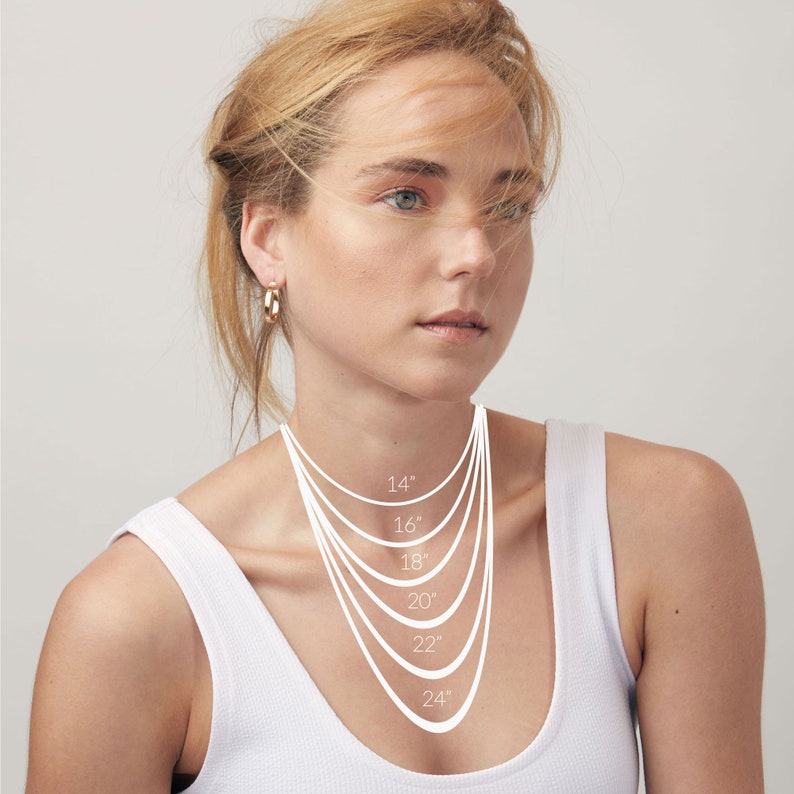 May include: A model wears a white tank top and a variety of silver necklaces, each labeled with a length in inches: 14", 16", 18", 20", 22", and 24".