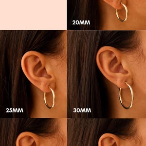 May include: A comparison of different sizes of gold hoop earrings, ranging from 20mm to 40mm in diameter. The earrings are 3mm wide. The image shows the earrings worn on a person's ear.