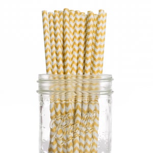 May include: A glass jar filled with yellow and white chevron patterned paper straws.