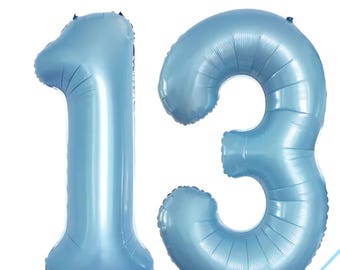 May include: Two large, light blue number balloons, forming the number 13. The balloons are inflated and have a metallic sheen. Ideal for a birthday or anniversary celebration. The balloons are against a white background.