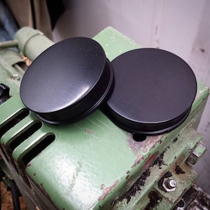 Custom-made flat flared plugs made of ebony