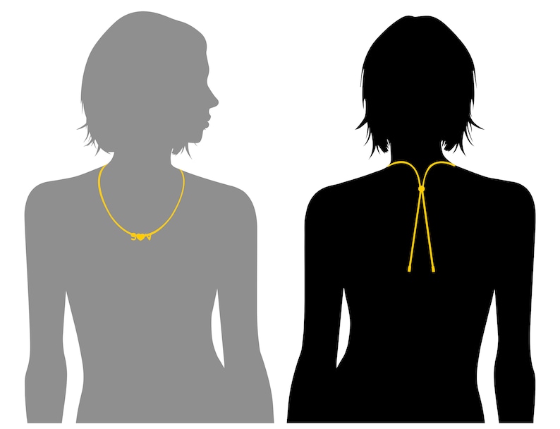 K&ouml;nnte beinhalten: Zwei Silhouetten von Personen, die eine goldene Halskette tragen. Die Halskette ist eine einfache Kette mit einem kleinen Anh&auml;nger. Die Silhouette links ist nach rechts gerichtet, und die Silhouette rechts ist nach vorne gerichtet.