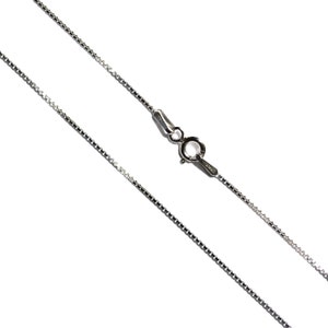 May include: A silver chain necklace with a lobster clasp.