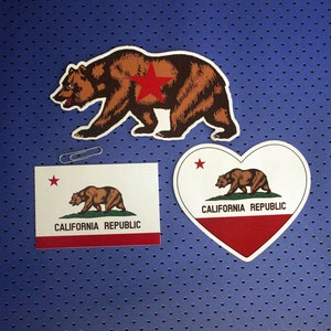 May include: Three stickers featuring a brown bear with a red star on its chest and the words "California Republic". The stickers are on a blue background with a dotted pattern.