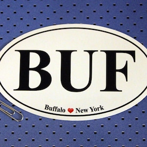 May include: White oval sticker with black text that reads "BUF" and the words "Buffalo ♥ New York".