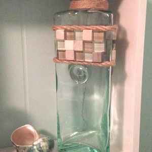 Green tinted triangular glass container