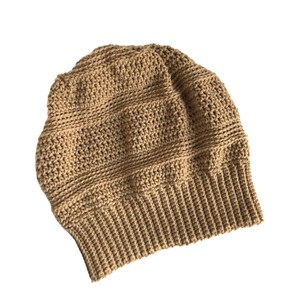 May include: A brown crocheted beanie hat with a ribbed brim.