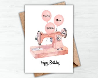 May include: A watercolor birthday card featuring a pink sewing machine with three pink balloons that read "You're Sew Special." The words "Happy Birthday" are written below the sewing machine in black script. The card is set against a brown paper envelope.
