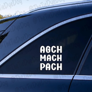 May include: A black car with a white vinyl sticker on the back window that says "AGCH MACH PACH".