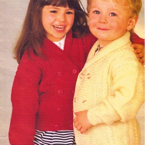 May include: Two children wearing knitted double-breasted cardigans. One child wears a red cardigan with large round buttons, the other a yellow cardigan. The image has the text "DOUBLE KNITTINGS" at the top and "Easy knit" in the upper right corner.