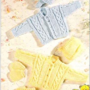 May include: Two knitted baby sets, one in light blue and one in yellow. The sets include a cardigan, hat, and booties. The sets are made with a cable knit pattern. The image includes the text "Double Knitting" and "Tiny sizes for early babies".
