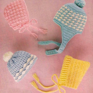May include: Four handmade crochet baby hats in pastel shades. A pink bonnet with a bow, a light blue hat with white detailing and a pom-pom, a blue hat with white trim, and a yellow bonnet with tassels.