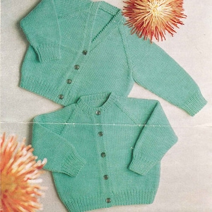 May include: Two knitted cardigans in a light green colour. One cardigan has a V-neck and the other has a round neck. Both cardigans have button fastenings.