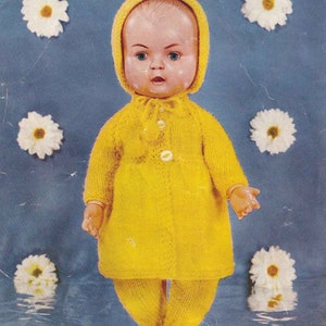 May include: A vintage doll wearing a bright yellow knitted outfit, including a hooded coat and leggings. The doll has a pale complexion, blue eyes, and is surrounded by white daisy decorations against a blue background.