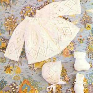 May include: A white knitted baby outfit with a diamond pattern. The outfit includes a cardigan, bonnet, and booties.
