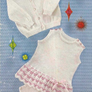 May include: A vintage baby clothing set, featuring a white knitted cardigan with button closures, a sleeveless dress, and matching bloomers. The dress and bloomers have a scalloped pink trim and a pink bow. The background is a light blue.