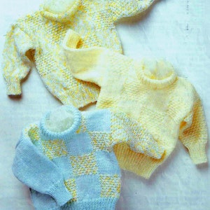 May include: Three knitted sweaters in pastel shades. One is light blue with a yellow checkerboard design, and two are yellow with speckled patterns. The sweaters have ribbed cuffs and collars. The image is on paper with text that reads "WOOL SHOP, 91a Lumley Rd., Skegness."