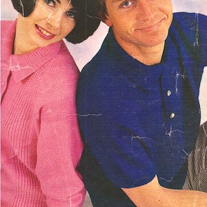 May include: A couple wearing casual clothing. The woman is wearing a pink sweater and the man is wearing a blue polo shirt and plaid pants.