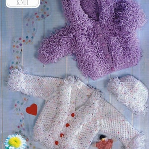 May include: Two knitted baby jackets with a fluffy texture. The purple jacket has a hood and is 41-56 cm in size. The white jacket has a speckled pattern and red buttons. The text "DOUBLE KNIT" is visible in the image.