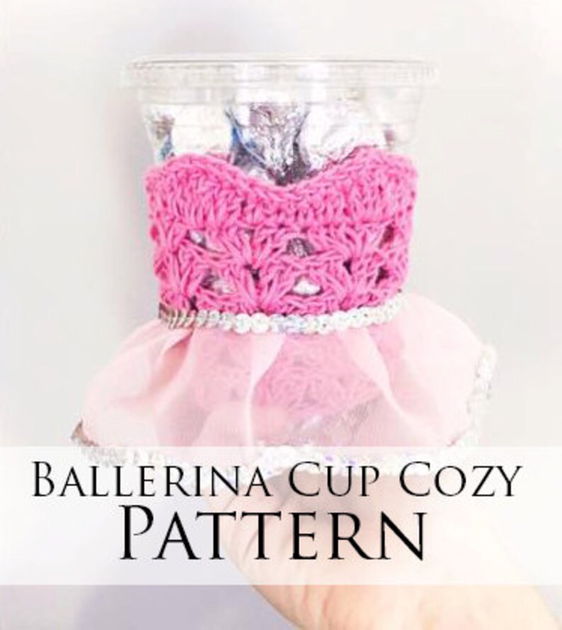May include: Pink crocheted ballerina cup cozy with a tulle skirt and a silver trim. The cozy is designed to fit a standard-sized cup. "Ballerina Cup Cozy Pattern" is written in black text on a white background.