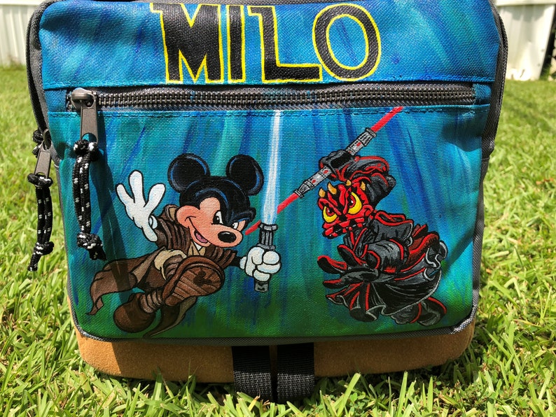 Custom painted backpack with three characters-