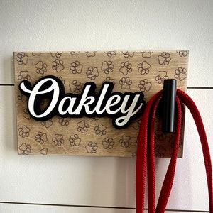 7.5"x4.5" Distressed mini pet leash holder with laser engraved paw prints in the background. Functional personalized and custom pet decor .