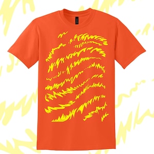 May include: Orange t-shirt with a yellow graphic design of abstract lines and shapes.