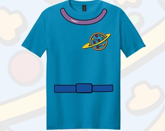 May include: A turquoise blue t-shirt with a cartoon planet design on the front. The planet is yellow with a brown ring and a pizza-like pattern. The shirt has a purple collar and a blue belt.