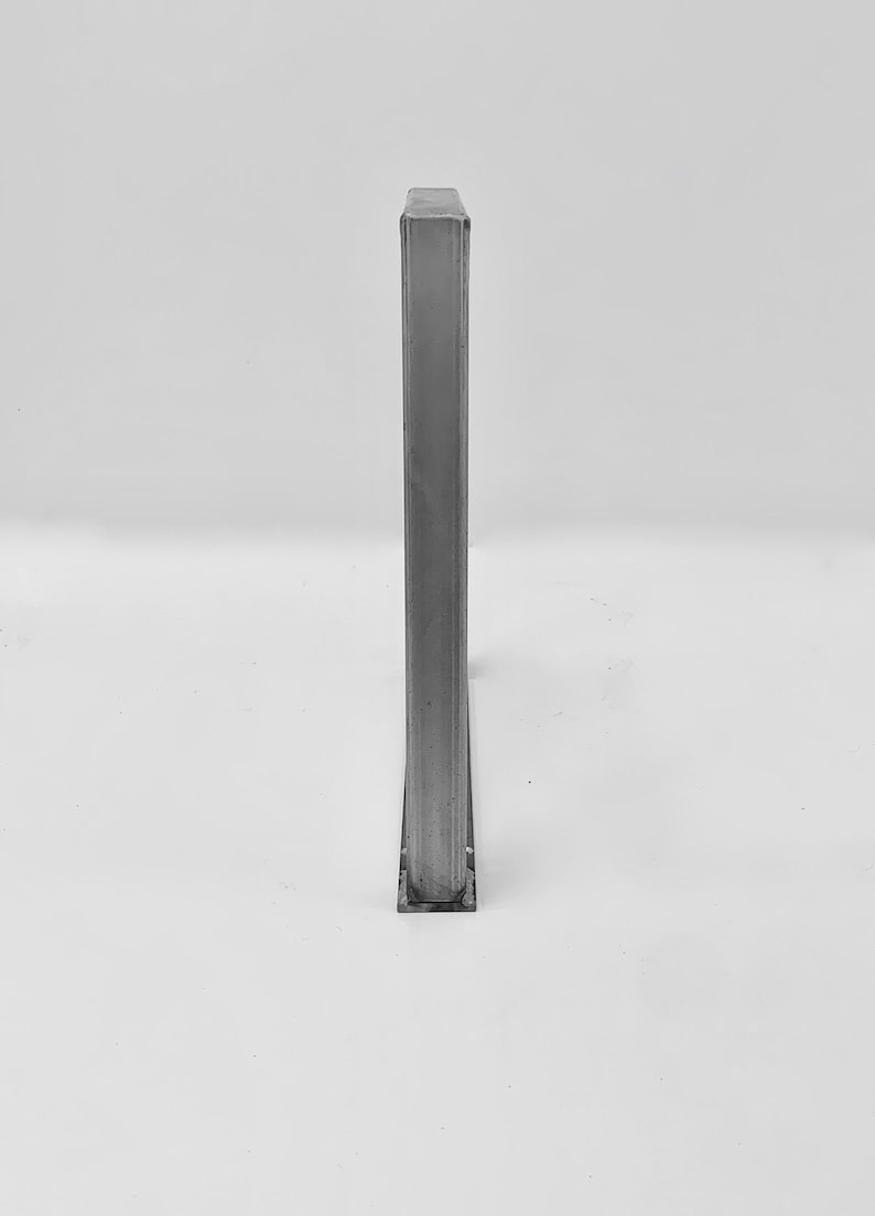 May include: A silver metal rectangular frame with a smooth surface.