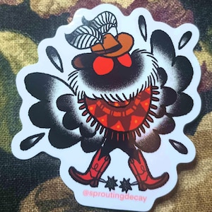 May include: A sticker featuring a cartoon moth character in a cowboy hat and boots. The moth has black wings, red eyes, and a patterned poncho. The sticker includes the text "@sproutingdecay".