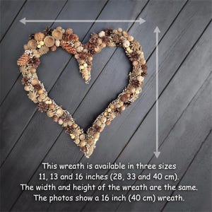 May include: A heart-shaped wreath made of natural materials like pinecones, acorns, and berries. The wreath is available in three sizes: 11, 13, and 16 inches. The photo shows a 16-inch wreath.