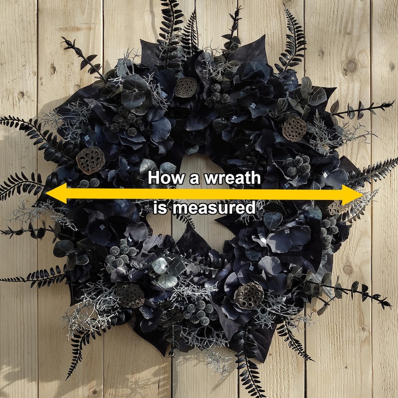 May include: A black and silver wreath with a yellow label that reads "How a wreath is measured".