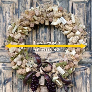 May include: A brown and beige cork wreath with a burlap bow and a cluster of purple grapes. The wreath is decorated with dried leaves and twigs. The text "How a wreath is measured" is written in yellow on a white background.