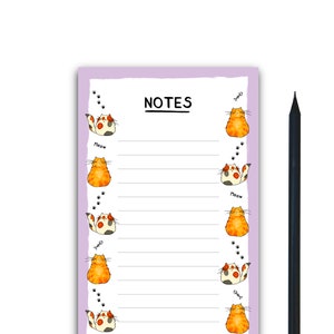 May include: A purple notepad with a white background and lined paper. The notepad has a cat illustration on each side and the word "NOTES" at the top. A black pencil is next to the notepad.