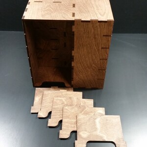 May include: A wooden box with a lid and five separate wooden dividers. The box is made of light brown wood and has a natural wood finish.