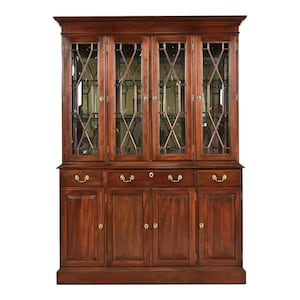 May include: A large, dark wood cabinet with glass-paned doors and brass hardware. The upper section features four glass doors with a diamond-patterned grid. The lower section has four solid wood doors and three drawers.