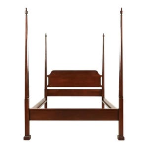 May include: A dark brown four-poster bed frame. The bed frame has a headboard with a curved top and two horizontal slats. The four posts are tall and slender, with decorative finials at the top.