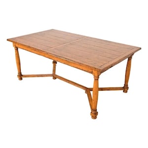 May include: A rectangular wooden dining table with a light brown finish. The table has a planked top and four turned legs. The table is approximately 72 inches long, 36 inches wide, and 30 inches high.