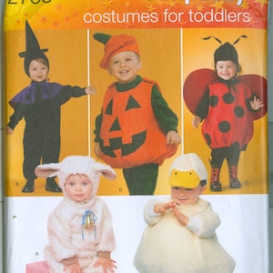 May include: Simplicity pattern 2788 features costumes for toddlers. The image shows five children in various costumes: a witch, a pumpkin, a ladybug, a lamb, and a duck. The costumes are in various colors, including black, orange, red, white, and yellow.