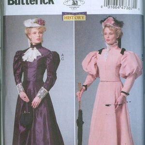 May include: A Butterick sewing pattern, B6537, featuring two Victorian era dresses. One dress is a deep purple with long sleeves and a high collar. The other is a light pink dress with a matching jacket and a long skirt.