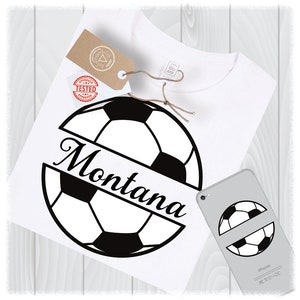 May include: A white t-shirt featuring a black and white football design. The football is cut in half with the name "Montana" written across the cut.