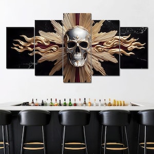 May include: A five-panel wall art piece featuring a metallic skull with a gold sunburst design against a black marble background. The artwork is displayed above a bar with black stools.