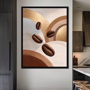 May include: A framed abstract art print featuring coffee beans floating against a backdrop of gold, brown, and cream-colored geometric shapes. The artwork has a modern aesthetic, suitable for kitchen or dining room decor.