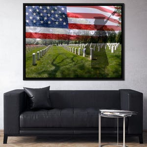 May include: A framed photograph of a military cemetery with a faded American flag overlayed on the image. The flag is waving in the wind and the cemetery is filled with white headstones.