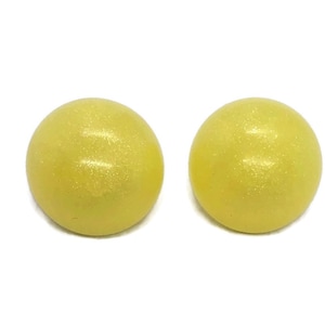 May include: A pair of yellow round stud earrings with a subtle shimmer.
