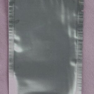 May include: A small, sealed, silver-colored pouch.