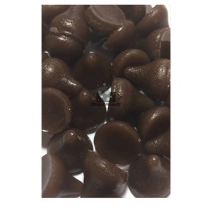 May include: A close-up of a pile of dark brown chocolate chips.