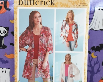May include: A sewing pattern for a long, open-front cardigan with a floral print. The pattern is from Butterick and is size ZZ (LRG-XLG-XXL).