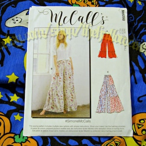 May include: A McCall's sewing pattern featuring a woman wearing floral print palazzo pants. The pattern includes multiple view options and simple instructions. The pattern is size ZZ (L-XL-XXL).